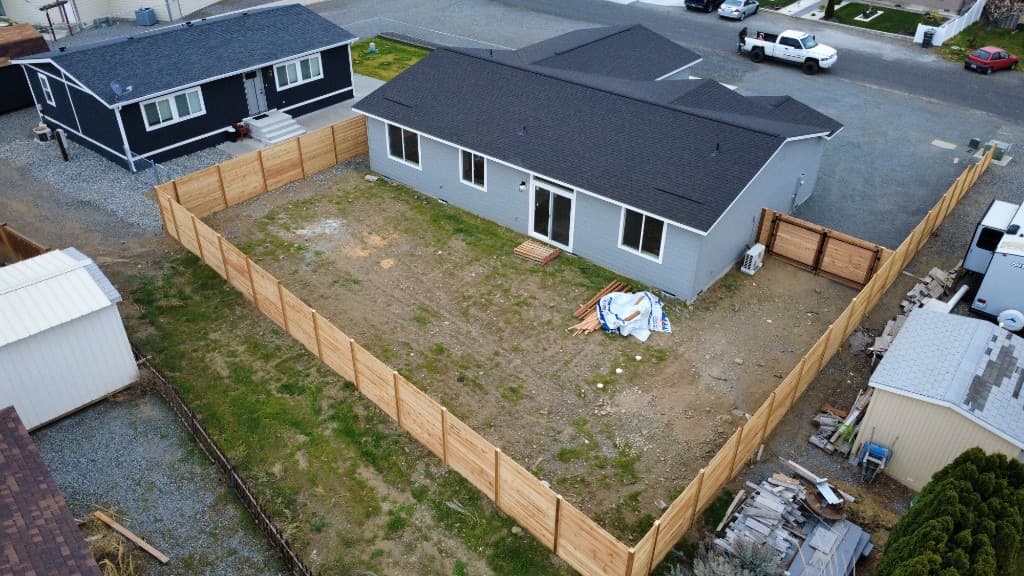 Aerial view of enclosed backyard with horizontal wood slat fencing