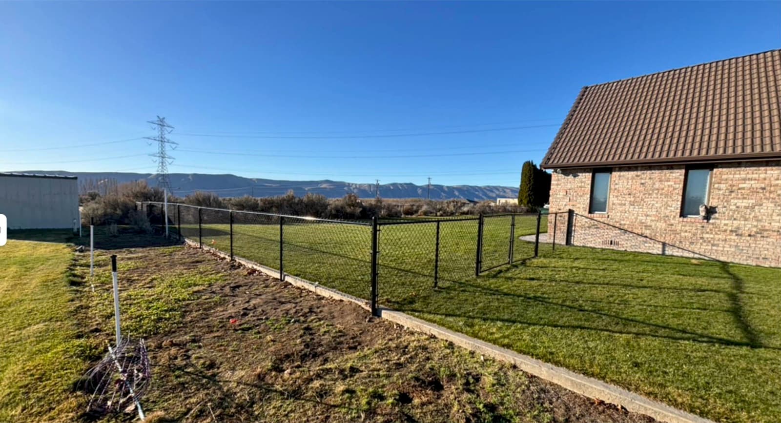 Black chain-link fence installation