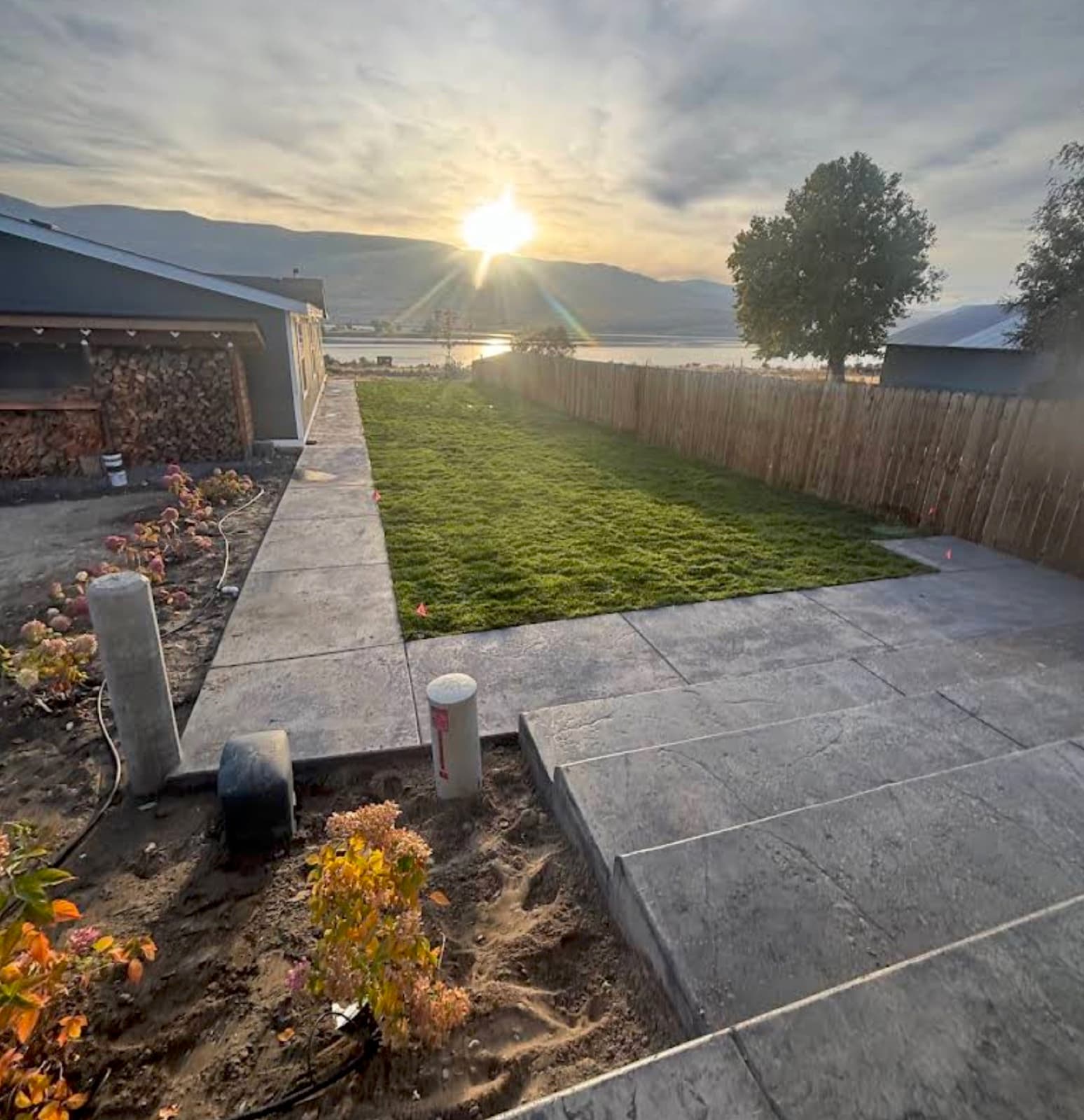 Stamped patio with new sod at sunset