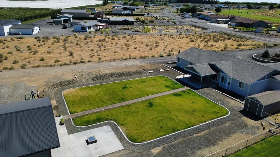 Aerial view of a paver walkway, lawn, and curbing in Desert Aire