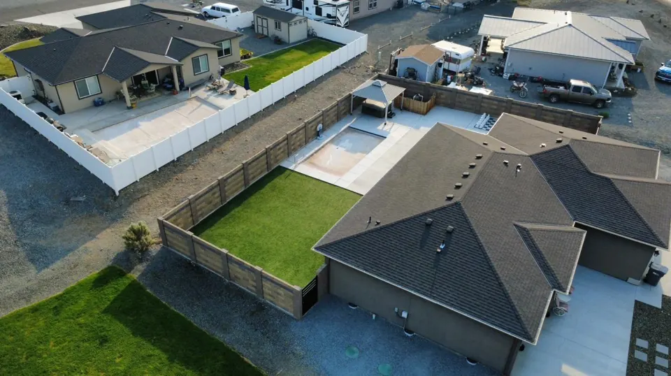 Aerial view of a completed block fence and iron gates