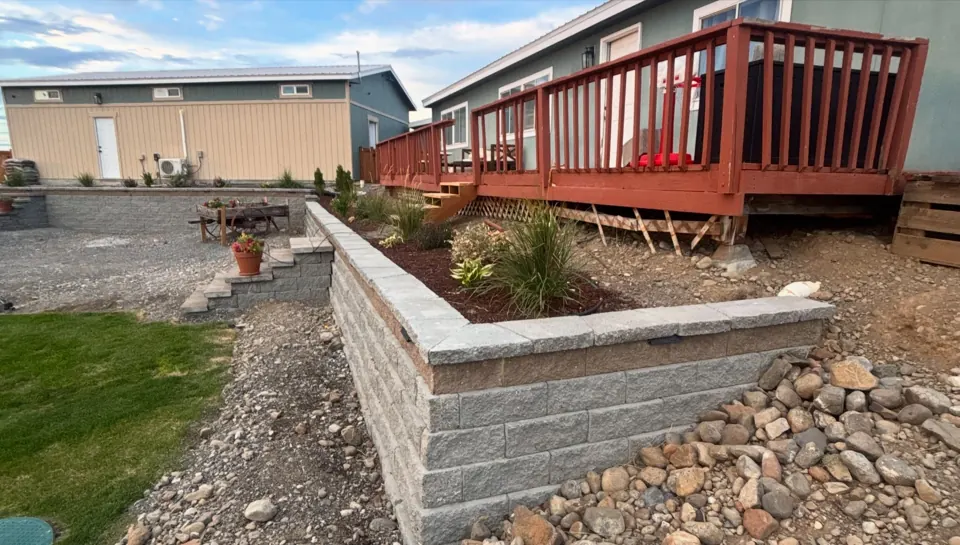 Retaining wall and garden bed beside a deck in Desert Aire